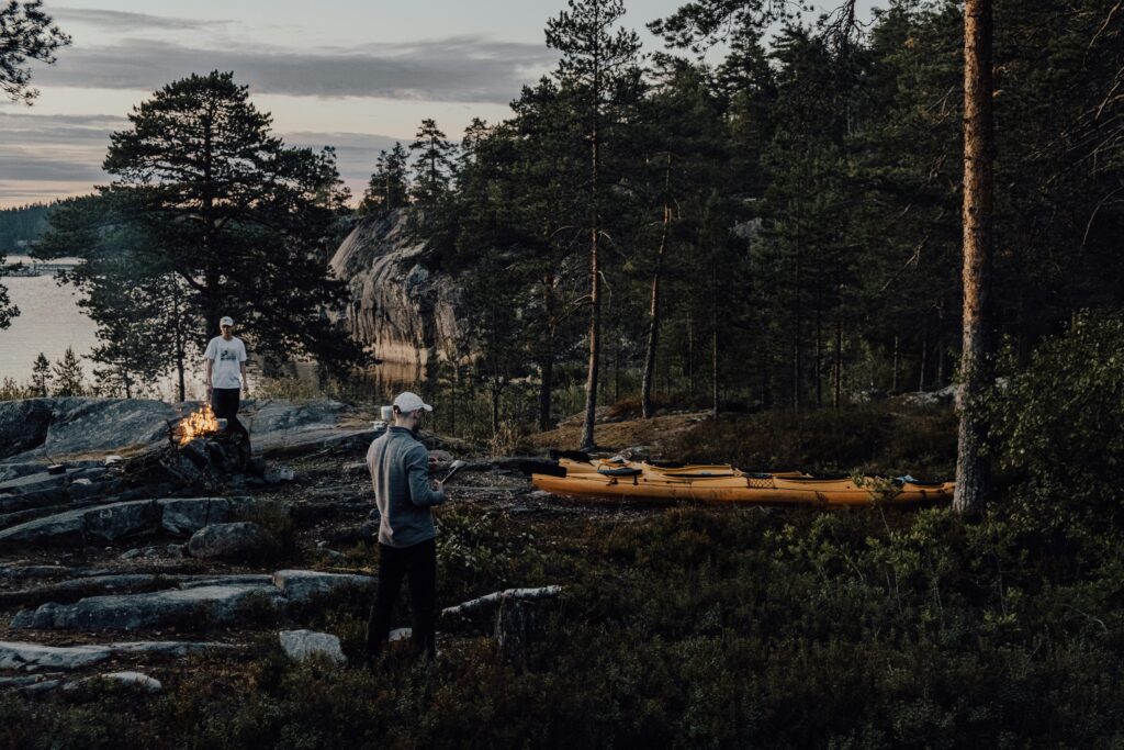 Two men camping and kayaking in the forested Ruskeala, Karelia, Russia.